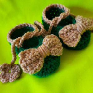 newborn baby skin and green handmade shoes